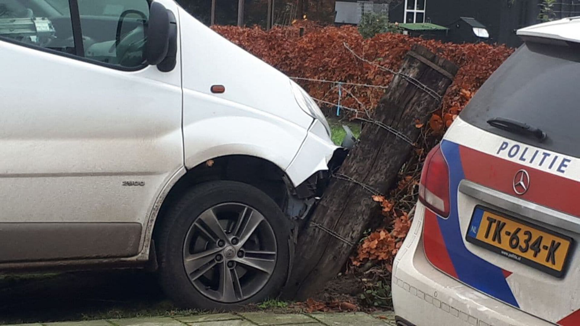 Camper ramt palen en komt tegen heg tot stilstand